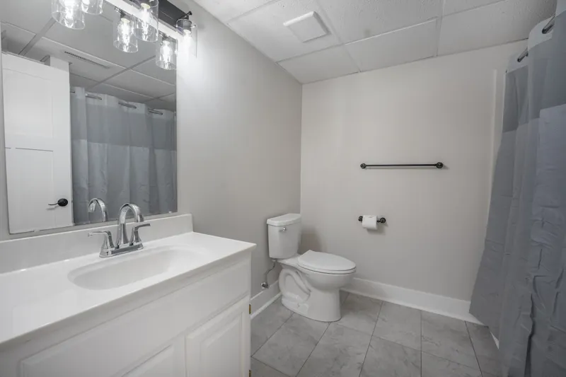 Lower-level bathroom with vanity and tub-shower